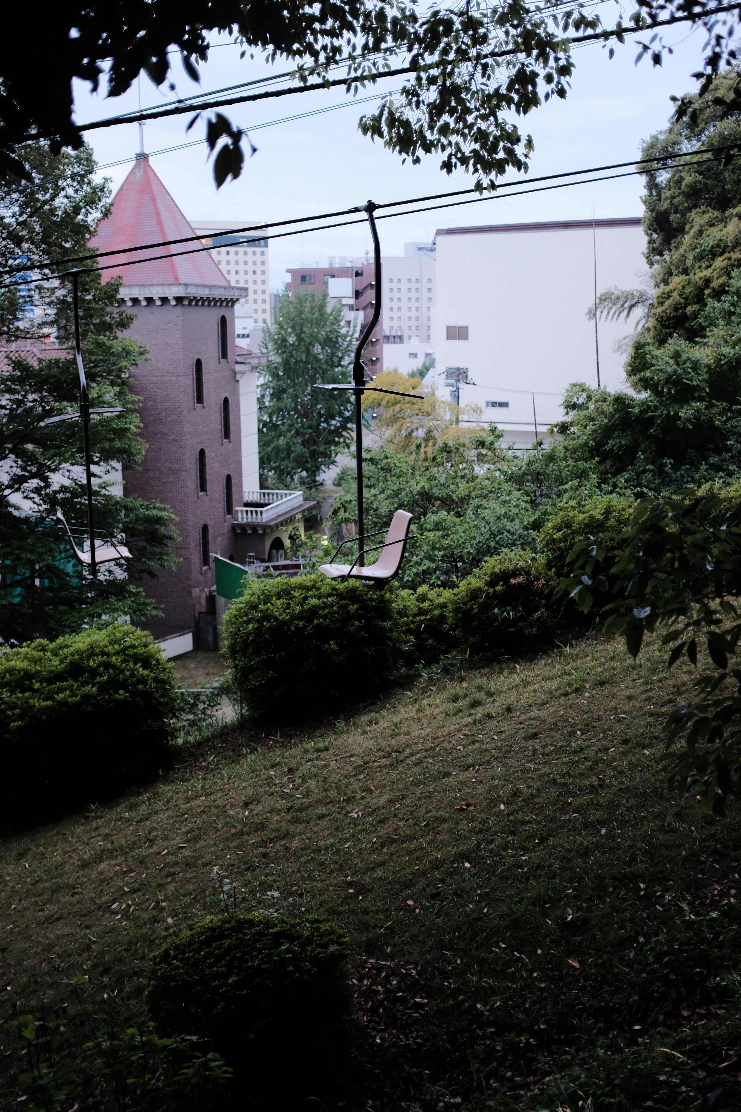 green grass lawn near white concrete building during daytime